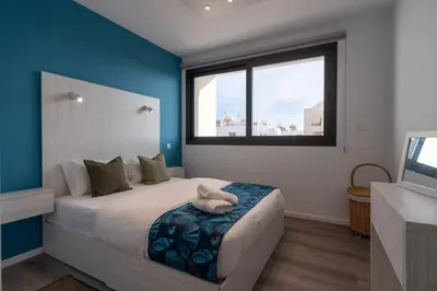 a bedroom with a large bed with a large window at Beachcomber 2-Bedroom Apartment in Larnaca in Larnaka