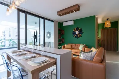 a living room with a table and a couch at Beachcomber 2-Bedroom Apartment in Larnaca in Larnaka
