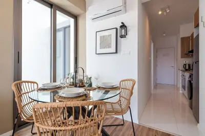 a dining room with a glass table and chairs at Stars 1-Bedroom Apartment in Larnaca in Larnaka
