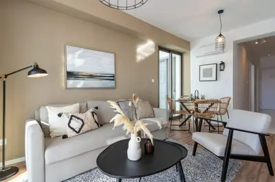 a living room with a couch and a table at Stars 1-Bedroom Apartment in Larnaca in Larnaka