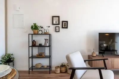 a living room with a chair and a table at Stars 1-Bedroom Apartment in Larnaca in Larnaka