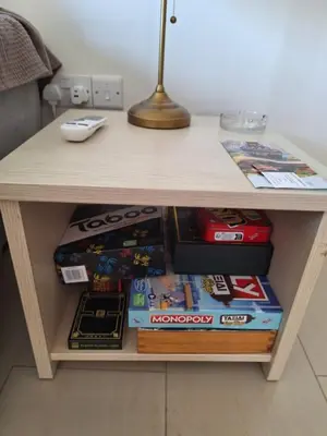 a table with a pile of books on it at Kyklades Resort Excellence in Paralimni