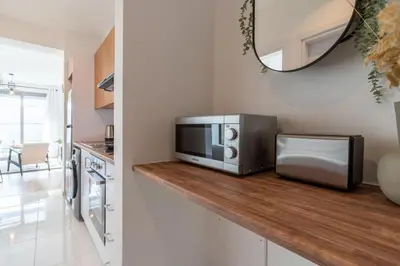 a microwave sitting on a counter in a kitchen at Moon Light 1-Bedroom Apartment in Larnaca in Larnaka