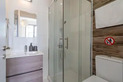 a bathroom with a shower and a toilet and a sink at Moon Light 1-Bedroom Apartment in Larnaca in Larnaka