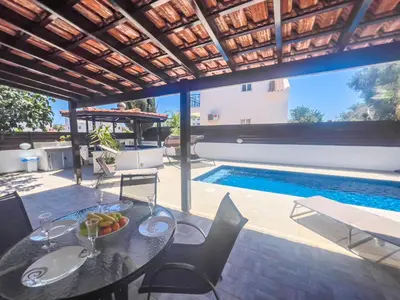 a table and chairs with a bowl of fruit on it at The Brilliant Villa in Protaras