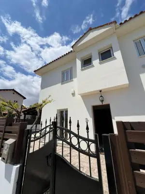 a white house with a black fence at The Brilliant Villa in Protaras