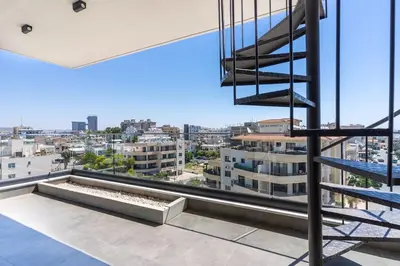 a view of a city from the balcony of a building at Maryam's 2-BR Apt Facing Larnaca Harbor With Pool in Larnaka