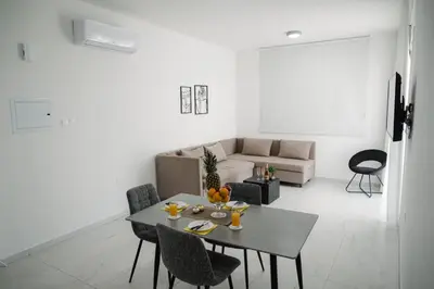 a living room with a table and a couch at Nissi Route 76 in Ayia Napa