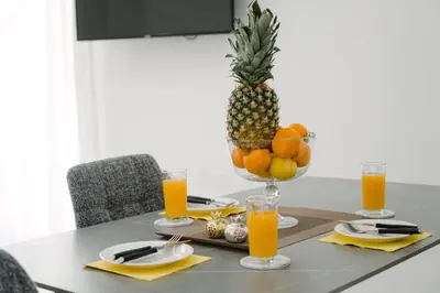 a table with a pineapple and a bowl of fruit at Nissi Route 76 in Ayia Napa