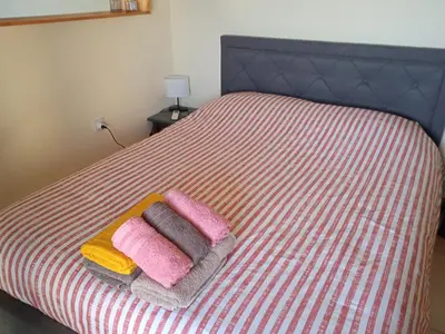 a bed with pink and yellow towels on it at Xylophagou Larnaca Ayia Napa Sunshine Apartments in Xylophaghou