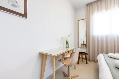 a desk in a room with a bed and a table at Attika Residence in Strovolos