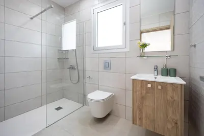 a bathroom with a toilet and a shower and a sink at Attika Residence in Strovolos