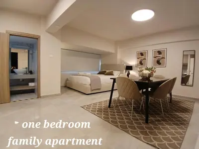 a bedroom with a bed and a table and chairs at Georgiana Suites in Larnaka