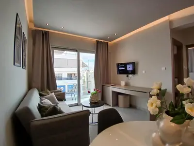 a living room with a couch and a table at Georgiana Suites in Larnaka