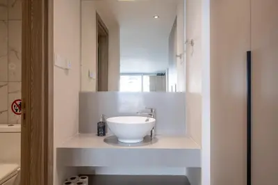 a bathroom with a white bowl sink on a counter at Georgiana Suites in Larnaka