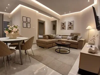 a living room with a couch and a table at Georgiana Suites in Larnaka
