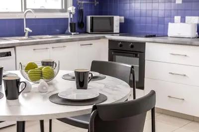 a kitchen with a table with a bowl of fruit on it at Luxurious Bright & Stylish 2BR with Office in Nicosia in Nicosia