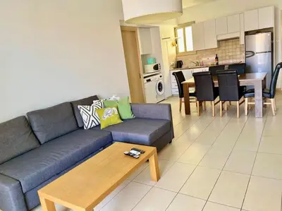 a living room with a couch and a table at Eliza Suite at Pernera Beach in Protaras
