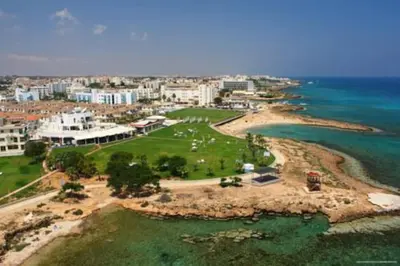 an aerial view of a beach with buildings and the ocean at Aphrodite Sea View Suite in Protaras