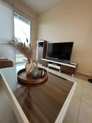 a living room with a tv and a coffee table at Mythical Sands - Evexia in Paralimni