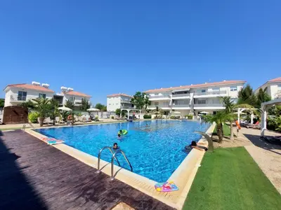 a swimming pool in a resort with people playing in it at Mythical Sands - Evexia in Paralimni