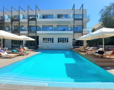 a swimming pool in front of a building at Mythical Sands - Evexia in Paralimni