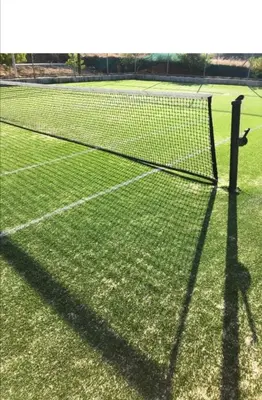 a tennis net on a tennis court at Mythical Sands - Evexia in Paralimni
