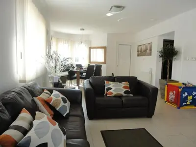 a living room with a black leather couch and chairs at 13 Crystal Lagoon Villa in Paralimni