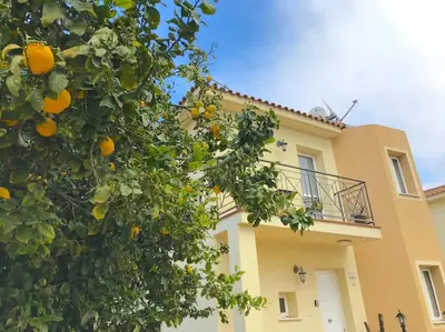 an orange tree in front of a house at 13 Crystal Lagoon Villa in Paralimni