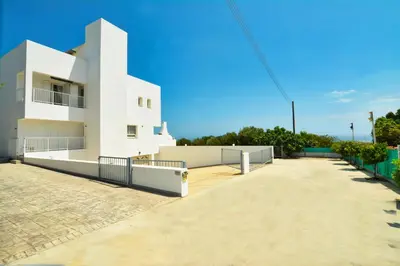 a white apartment building with a driveway in front of it at Villa Christina in Ayia Napa