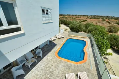 a swimming pool on the balcony of a house at Villa Christina in Ayia Napa
