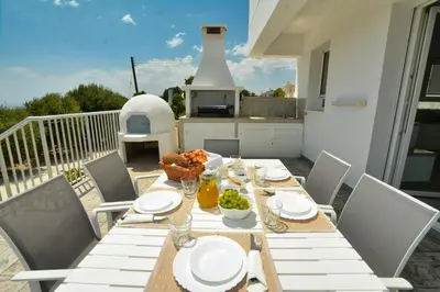 a table with plates and bowls of food on a patio at Villa Christina in Ayia Napa