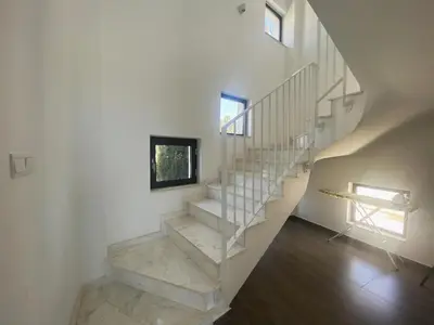 a staircase in a house with white walls at NISSI PEARL Holiday Villas Ayia Napa in Ayia Napa
