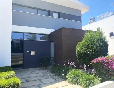 a house with a blue door and some plants at NISSI PEARL Holiday Villas Ayia Napa in Ayia Napa