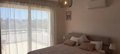 a bedroom with a bed and a large window at Nissi 3 Pool View 2 Bedroom Apartment with Large Veranda in Ayia Napa