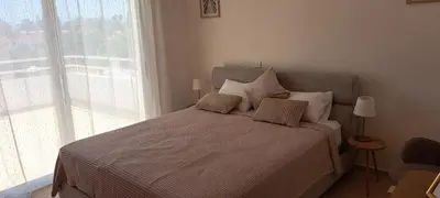 a bed in a bedroom with a large window at Nissi 3 Pool View 2 Bedroom Apartment with Large Veranda in Ayia Napa