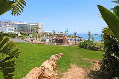 a view of the beach and a resort at Villa Artemis - 30m from Pernera Beach in Protaras