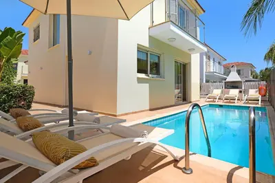 a villa with a swimming pool and a house at Villa Artemis - 30m from Pernera Beach in Protaras