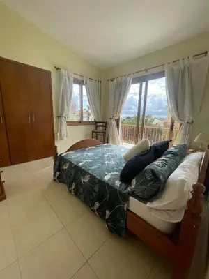 a bedroom with a bed with pillows and a window at Villa Annalisarose in Ayia Napa