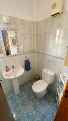 a bathroom with a toilet and a sink at Villa Annalisarose in Ayia Napa