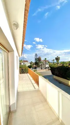 a balcony of a building with a view of a street at Villa Annalisarose in Ayia Napa