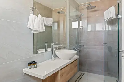 a bathroom with a sink and a glass shower at Serenity Waves Villa 12 in Sophtadhes