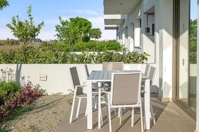 a table and chairs on the patio of a house at Serenity Waves Villa 12 in Sophtadhes