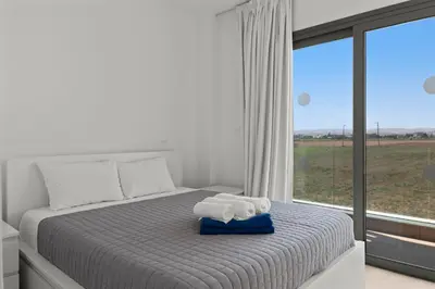a bedroom with a bed with two towels on it at Serenity Waves Villa 10 in Sophtadhes
