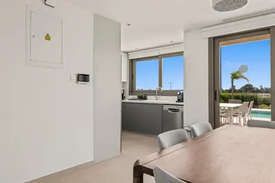 a kitchen and dining room with a table and chairs at Serenity Waves Villa 16 in Larnaka