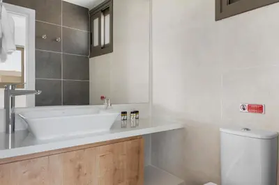 a bathroom with a sink and a toilet at Serenity Waves Villa 17 in Larnaka