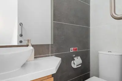 a bathroom with a white sink and a toilet at Serenity Waves Villa 17 in Larnaka