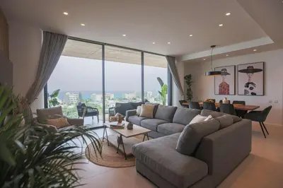a living room with a couch and a table at Shanti Tranquil Escapes in Paralimni