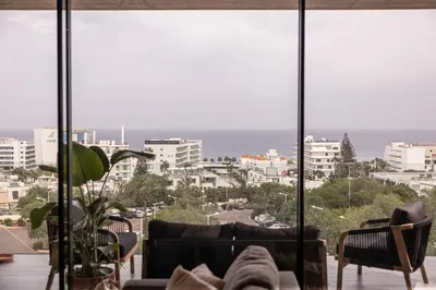 a living room with a view of the ocean at Shanti Tranquil Escapes in Paralimni