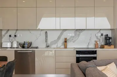 a kitchen with white cabinets and a counter top at Shanti Tranquil Escapes in Paralimni